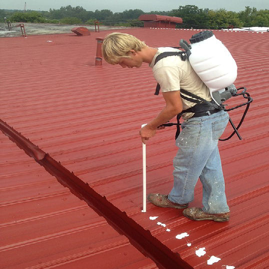 Man Spraying Elastomeric Coating on  Rooftop