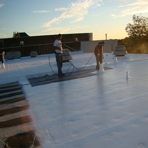 Two Workers Installing a Roof Coating
