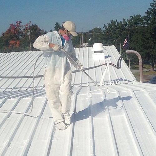 A Roofer Applies a Commercial Roof Coating